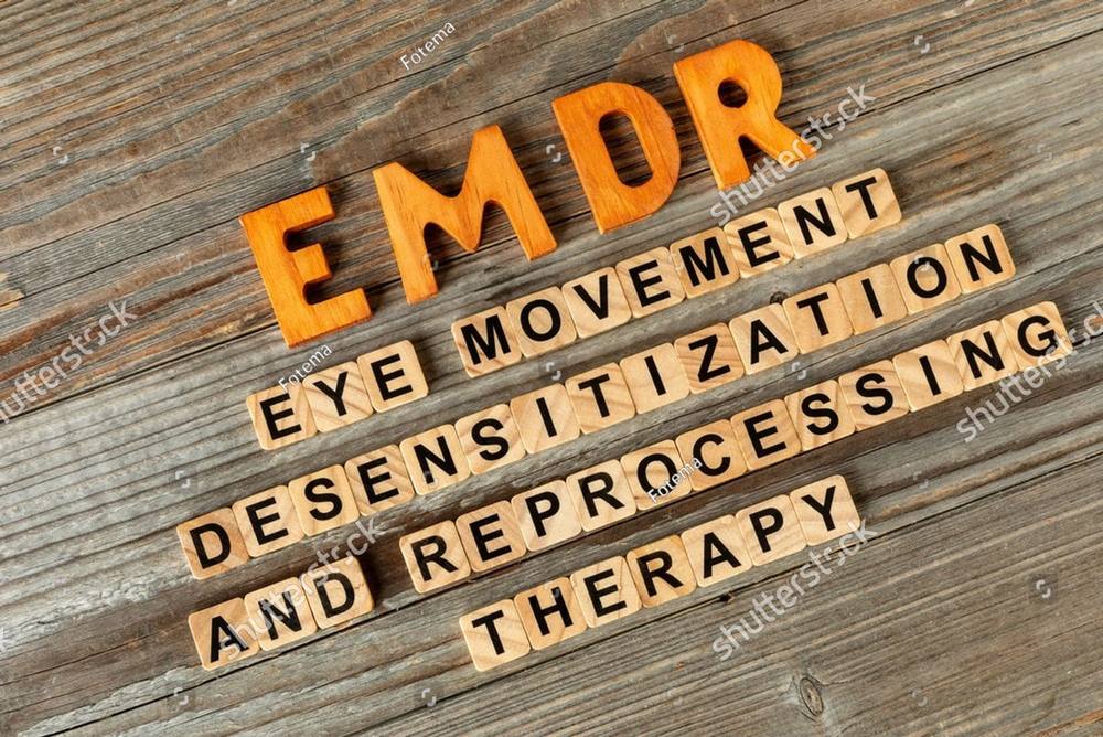 Wooden letter tiles spelling Eye Movement Desensitization and Reprocessing Therapy